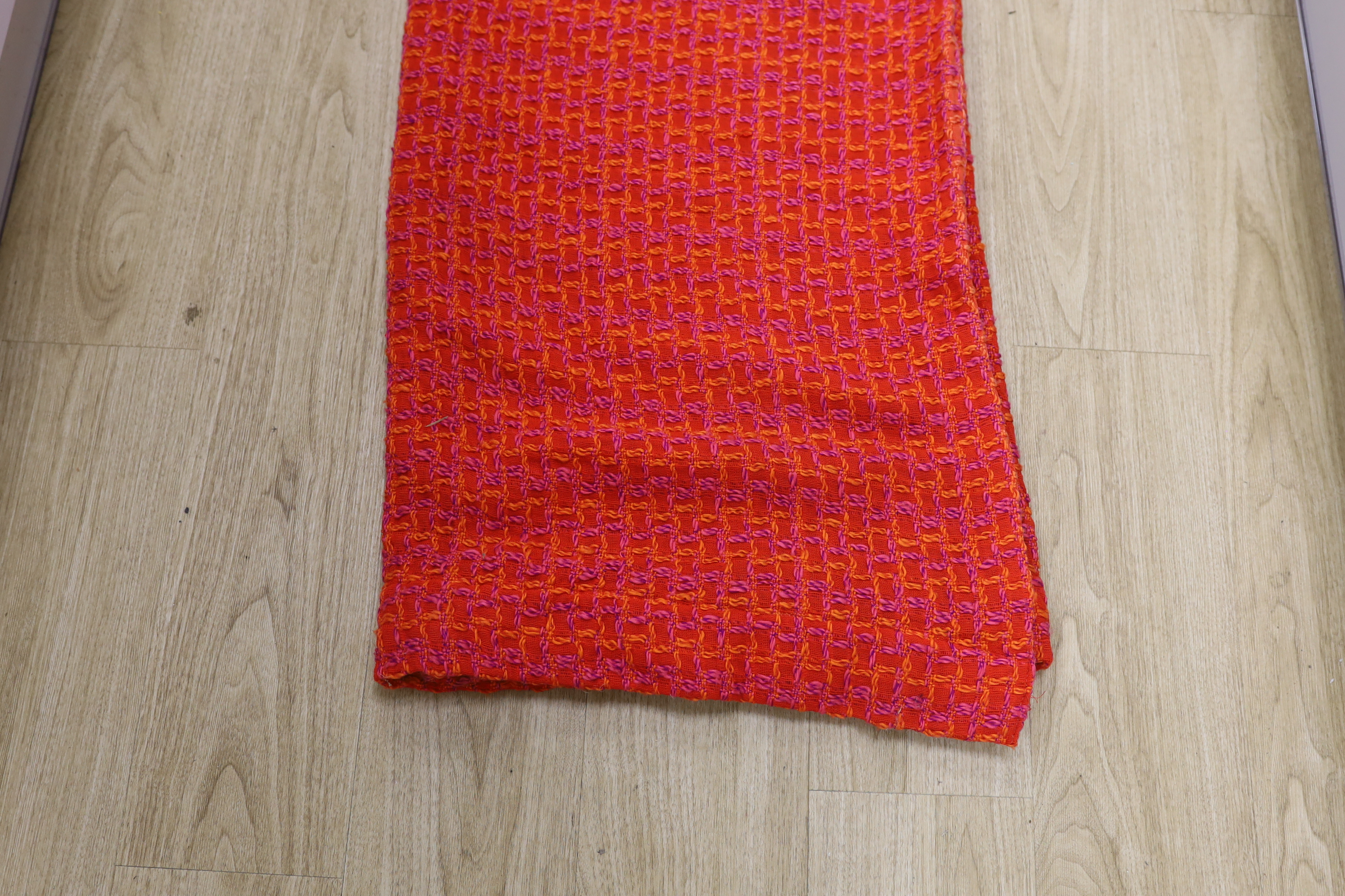 An unusual woven 1960's curtain in orange, pink and purple wools in a square overall pattern